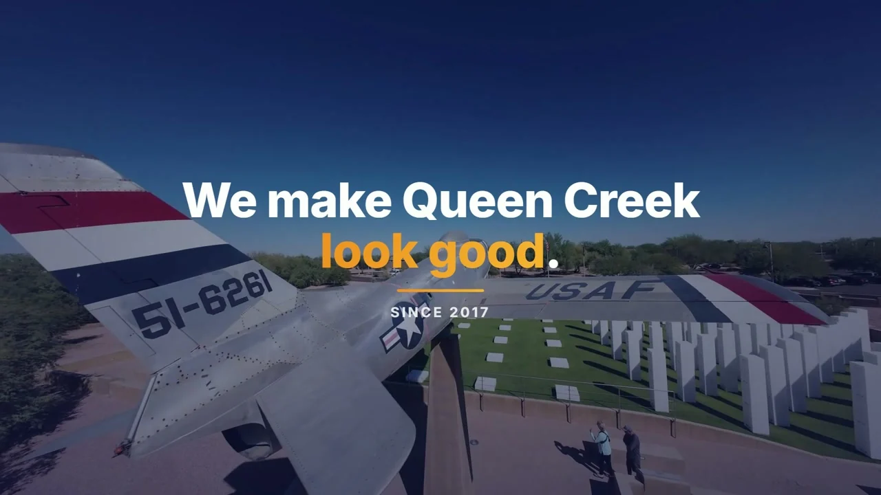 Aerial drone shot over a veterans memorial in Queen Creek, Arizona, with the words We make Queen Creek look good